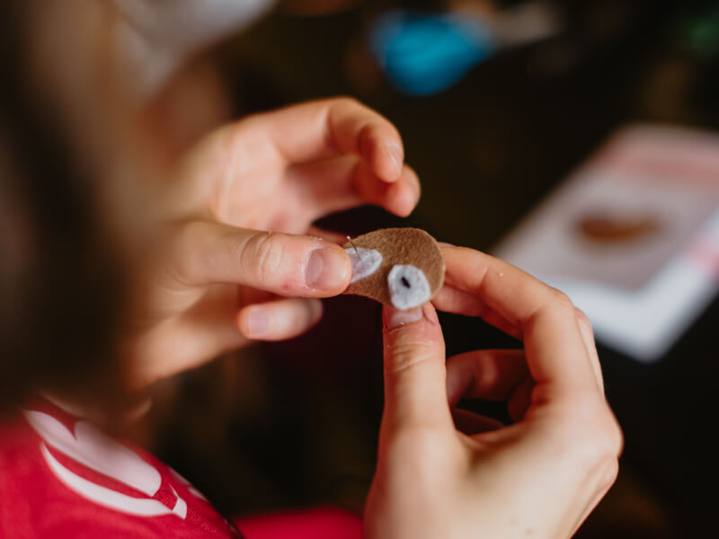 Close up image of hands holding thread